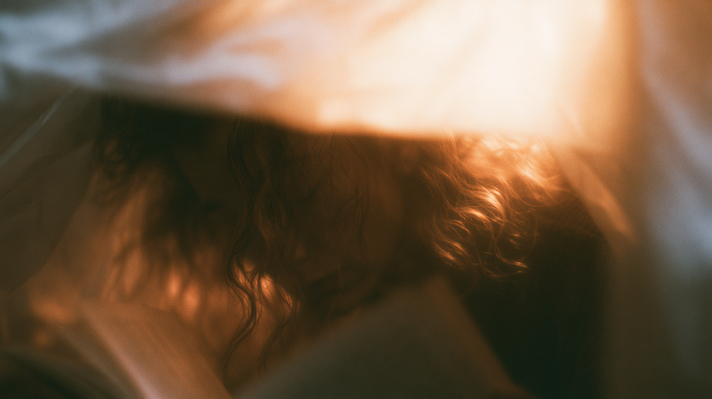 close-up, hair lit warm under fabric